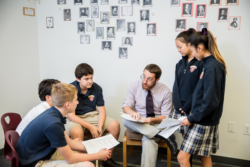 Teacher in discussion with scholars