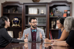 Man sitting at conference table with others