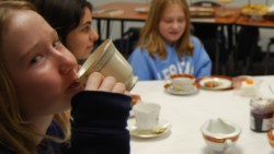 Student sipping cup of tea