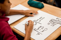 student working out a math problem