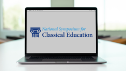 laptop with National Symposium logo on the screen