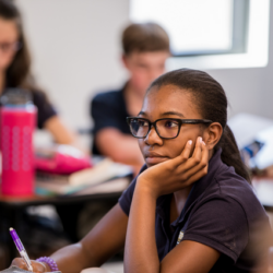 Student at desk looking forward