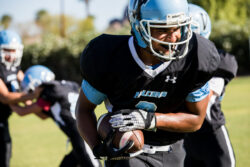 Student athlete playing football.