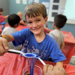 Student playing with slime at summer camp