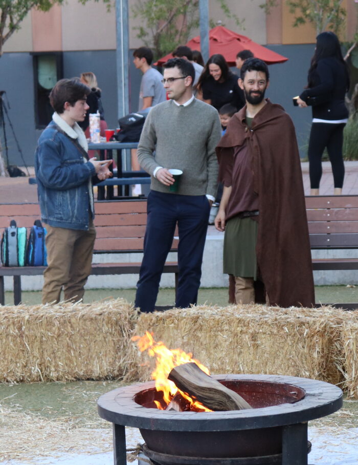 Student and faculty by bonfire at Cicero's Beowulf event