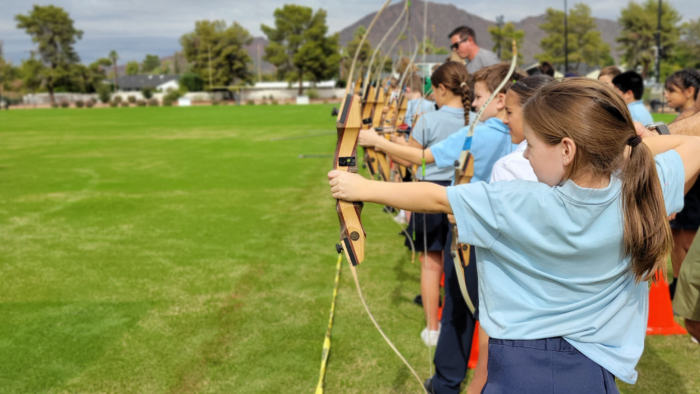 Students doing archery during Robin Hood Day
