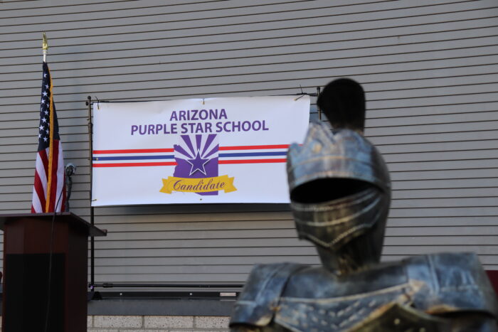Arizona Purple Star School Banner next to Trivium mascot, a knight.