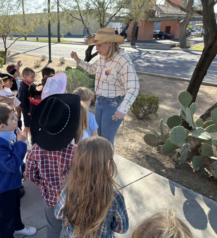 Cicero student dressed like pioneers taking a nature walk for Arizona's birthday.