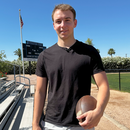 Veritas Alumni Brody Richter holding a football