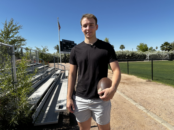 Veritas Alumni Brody Richter holding a football