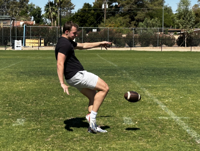 Veritas Alumni Brody Richter kicking a football