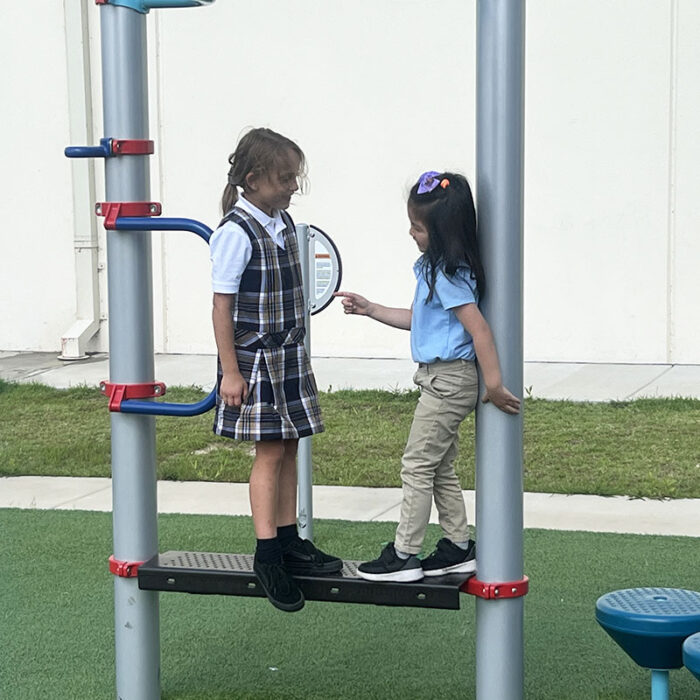 Two students on playground at Harveston Kinder Readiness Program