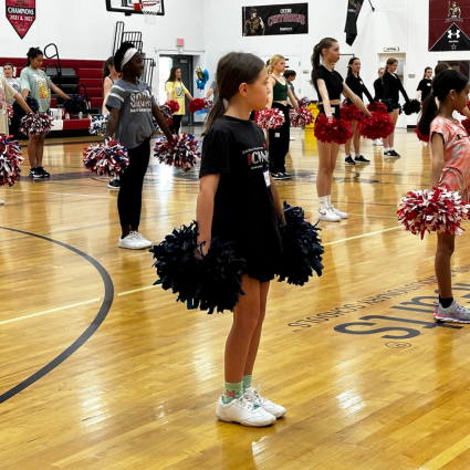 Group of girls with pom poms at Cheer Clinic
