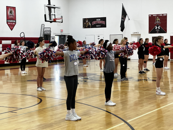 Group of girls with pom poms at Cheer Clinic