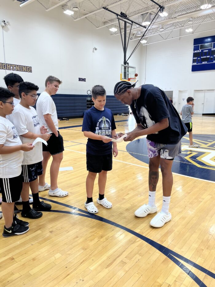 Jalen Williams signing autographs Lincoln Prep athletes at Summer Basketball Camp
