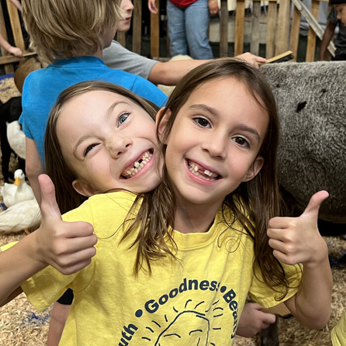 Two girls at the petting zoo at Summer Camp