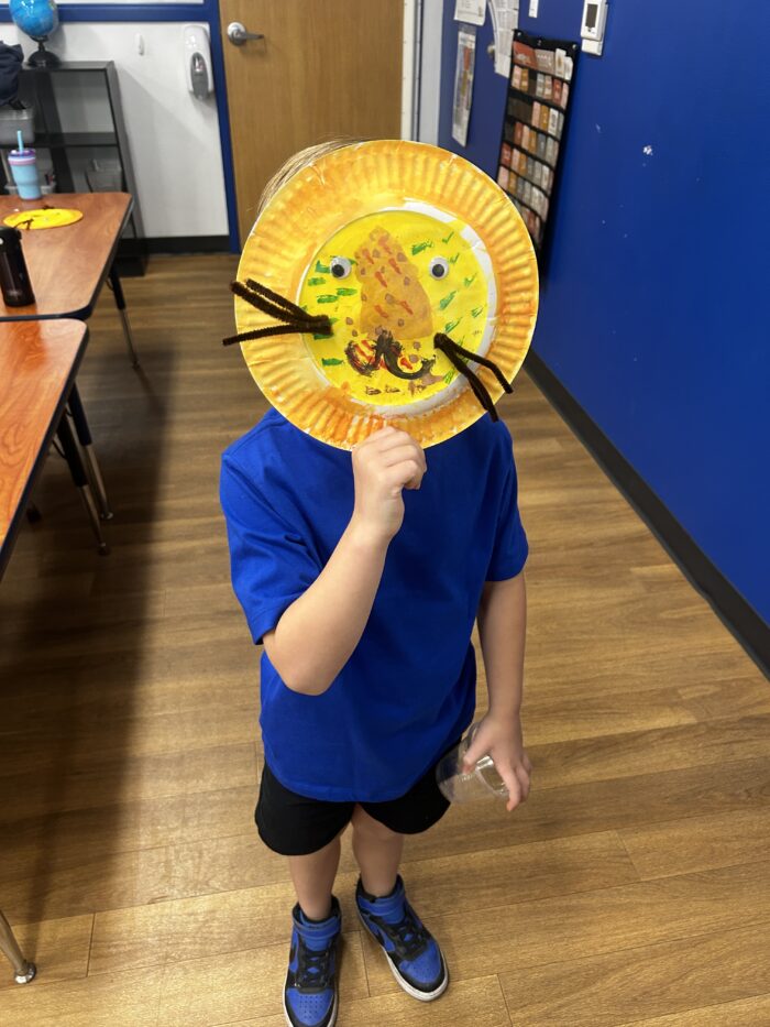Summer camp scholar with a lion mask