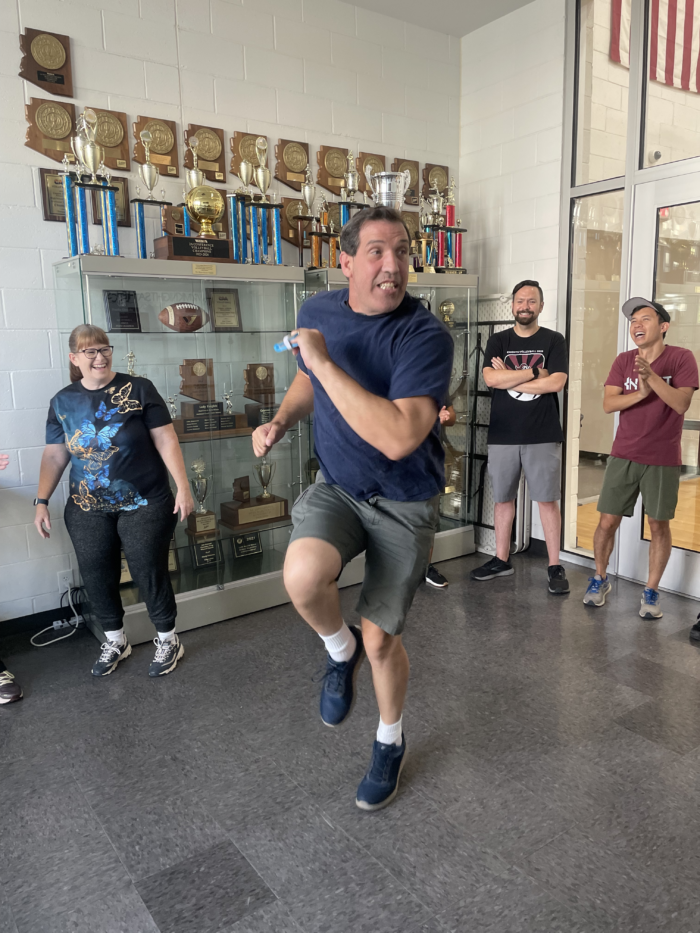 Staff member participating in break dance competition at the Trivium Prep Staff Olympic Games