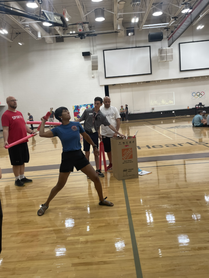 Staff member participating in shot put competition at the Trivium Prep Staff Olympic Games