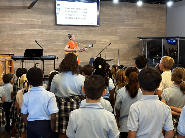 Music Teacher leading a song during chapel at Great Hearts Christos in Gilbert