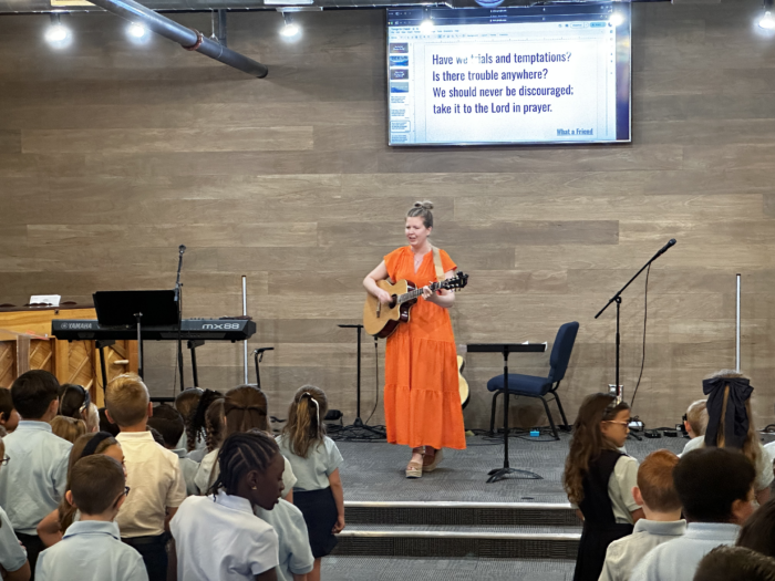 Music Teacher leading a song during chapel at Great Hearts Christos in Gilbert