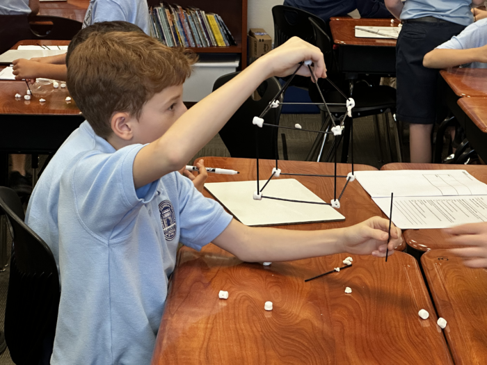 Fourth grade boy working on a science project