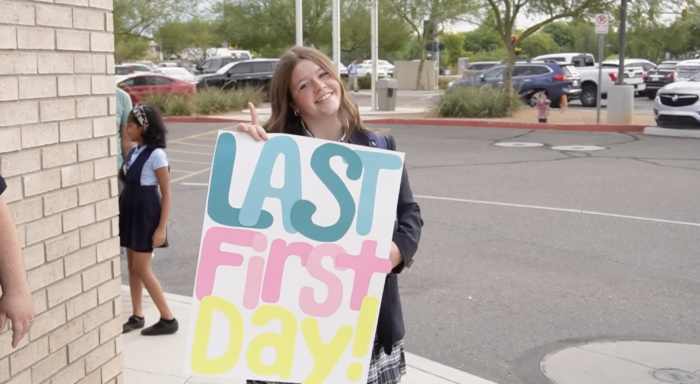 Senior girl holding a Last First Day sign