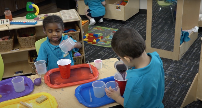 Preschool students at water table