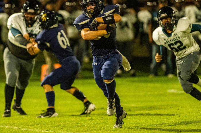 Glendale Prep Griffin football player running with ball