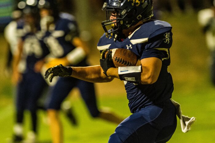 Glendale Prep Griffin football player running with ball