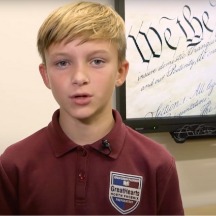 Male student in front of screen with the preamble