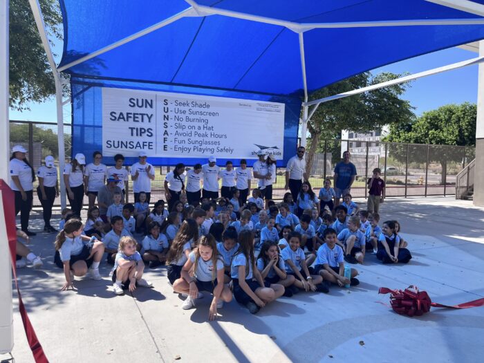 Group of students under a shade structure