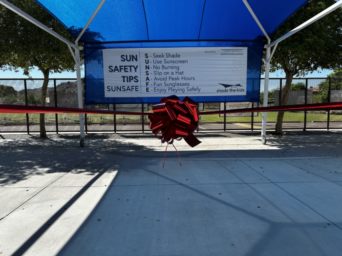 Shade structure with red ribbon and bow