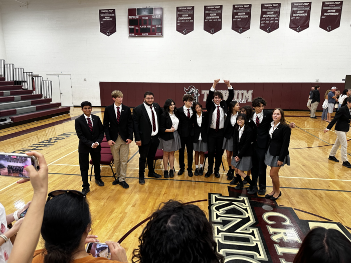 Group of students in uniforms getting their picture taken