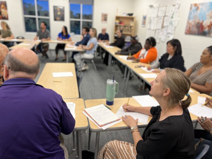 Parents taking notes at Curriculum Night