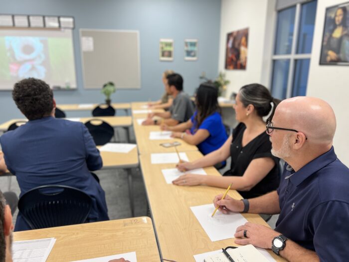 Parents taking notes at Curriculum Night