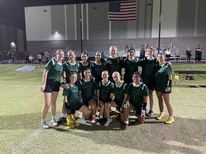 Girls' flag football team in uniform on the field.