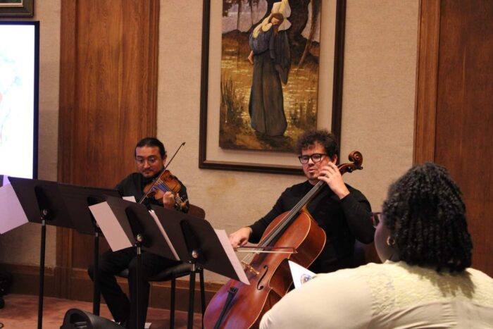 Dr. Duarte playing cello with other musicians