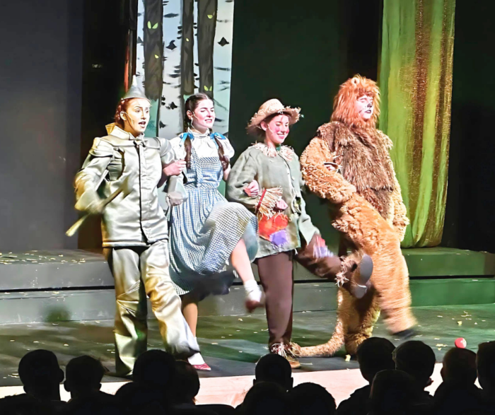 The Tinman, Dorothy, Scarecrow, and the Lion on stage