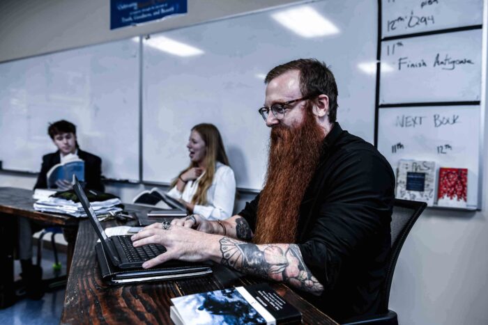 Dr. James Hall sitting at a laptop