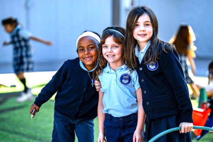 Three female students on a playground