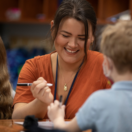 Female teacher working with a young student