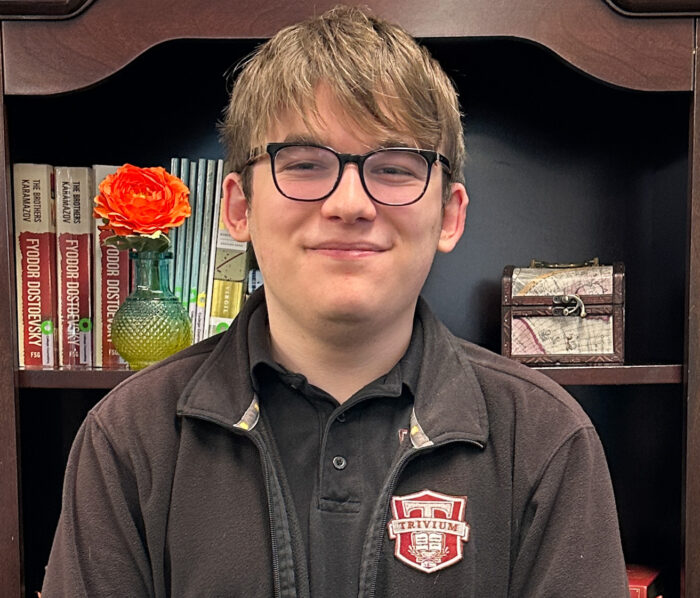 male student in front of bookcase