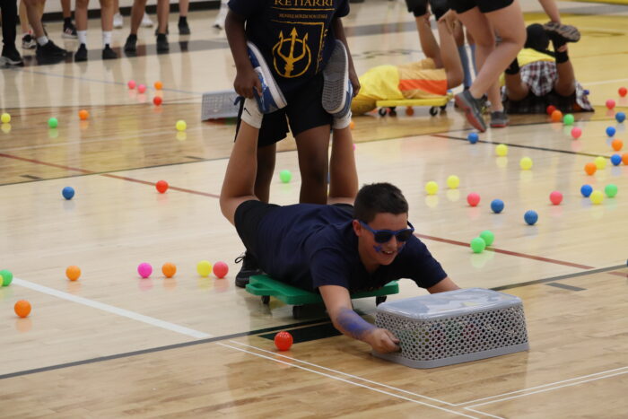 Student playing life-sized "Hungry Hungry Hippo