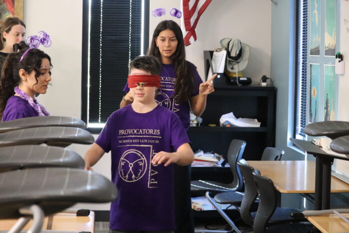 Blindfolded student going through an obstacle course