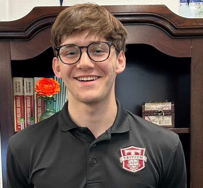 Male student in front of bookcase