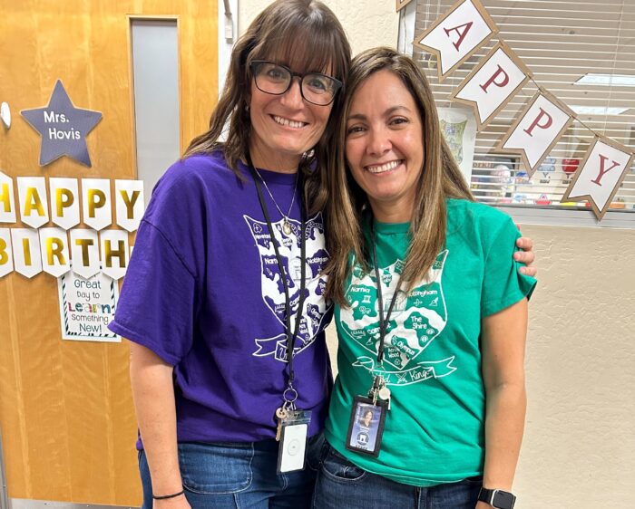 Two teachers wearing Kingdom shirts