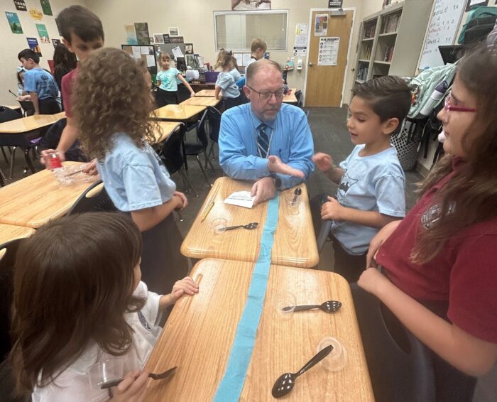 Teacher working on a project with students