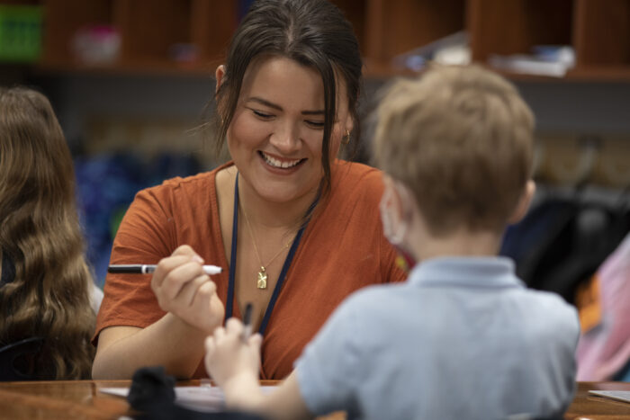 Female teacher working with a young student