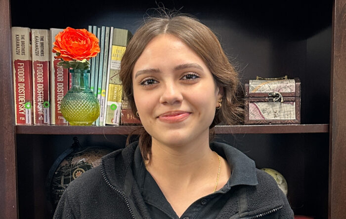 Female student in front of bookcase